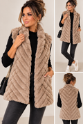 Luxe taupe bamboo-fur gilet with chevron texture and open front, worn with jeans and trainers