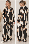 Model wearing burnt abstract print relaxed co-ord set with button-through shirt and wide-leg trousers